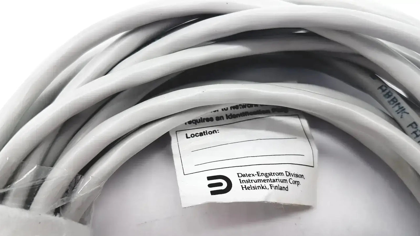A coiled white datex-extension mon aic network cable 20ft from datex-engstrom division of instrumentarium corp