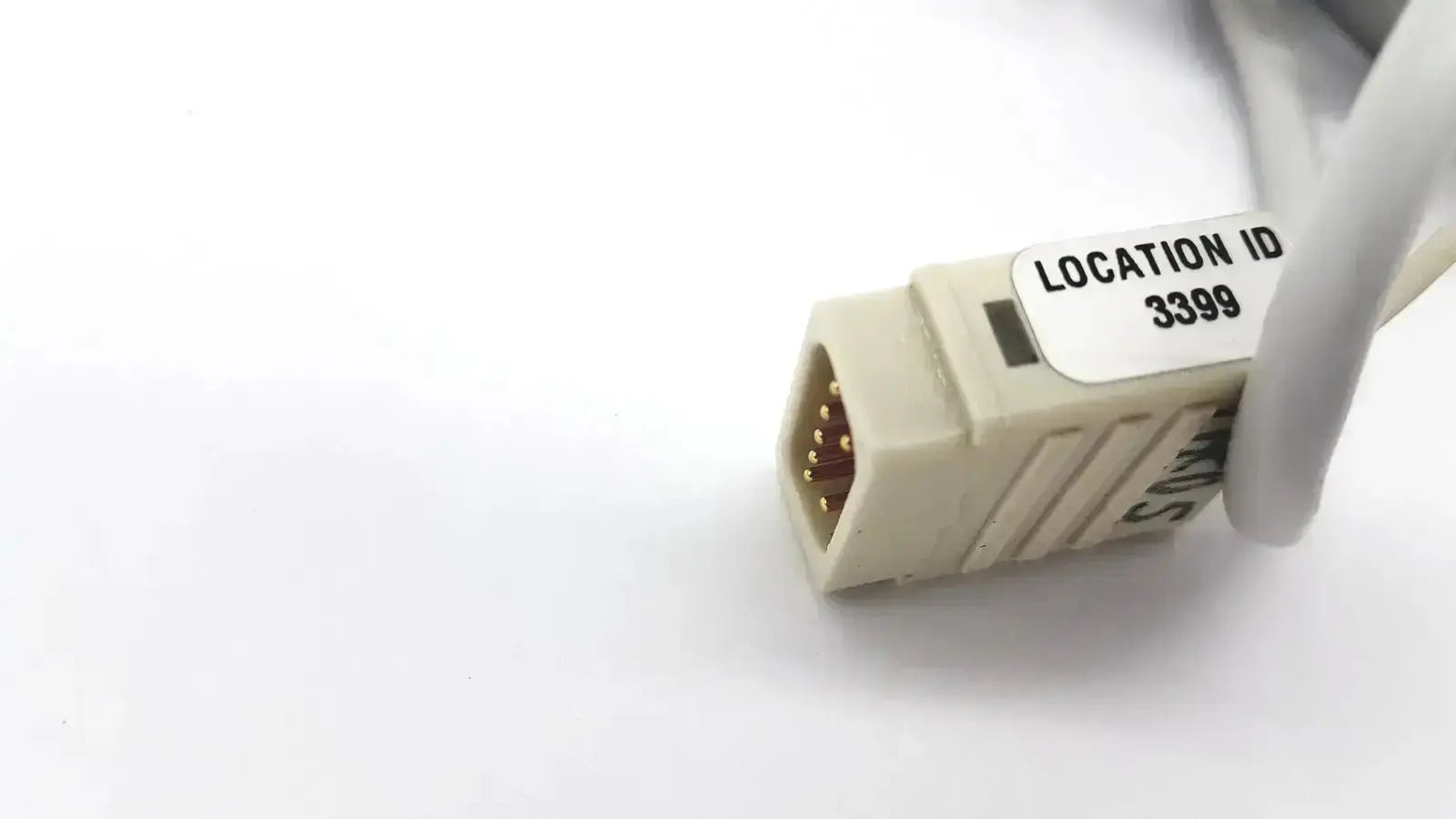 Beige Datex extension mon AIC network cable connector with gold-plated pins and location id 3399 label