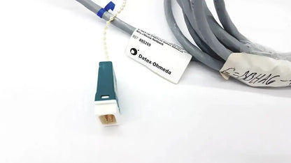 Gray Datex Ohmeda mon ic network cable with teal and white connector labeled datex-ohmeda 10ft length
