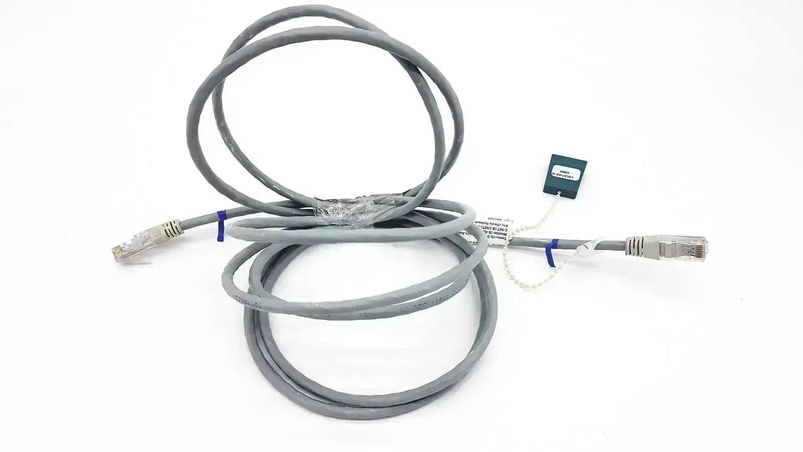 Gray Datex Ohmeda mon ic network cable with silver RJ45 connectors and green tag, 10ft length