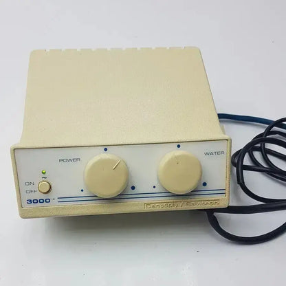 Cream-colored dentsply cavitron 3000 prophylaxis unit type-gen control box with power and water knobs and green indicator