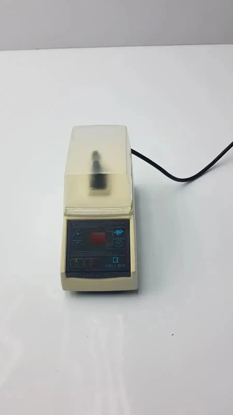 Beige dentsply rinn crescent laboratory centrifuge with transparent lid and control panel featuring red button and blue icons