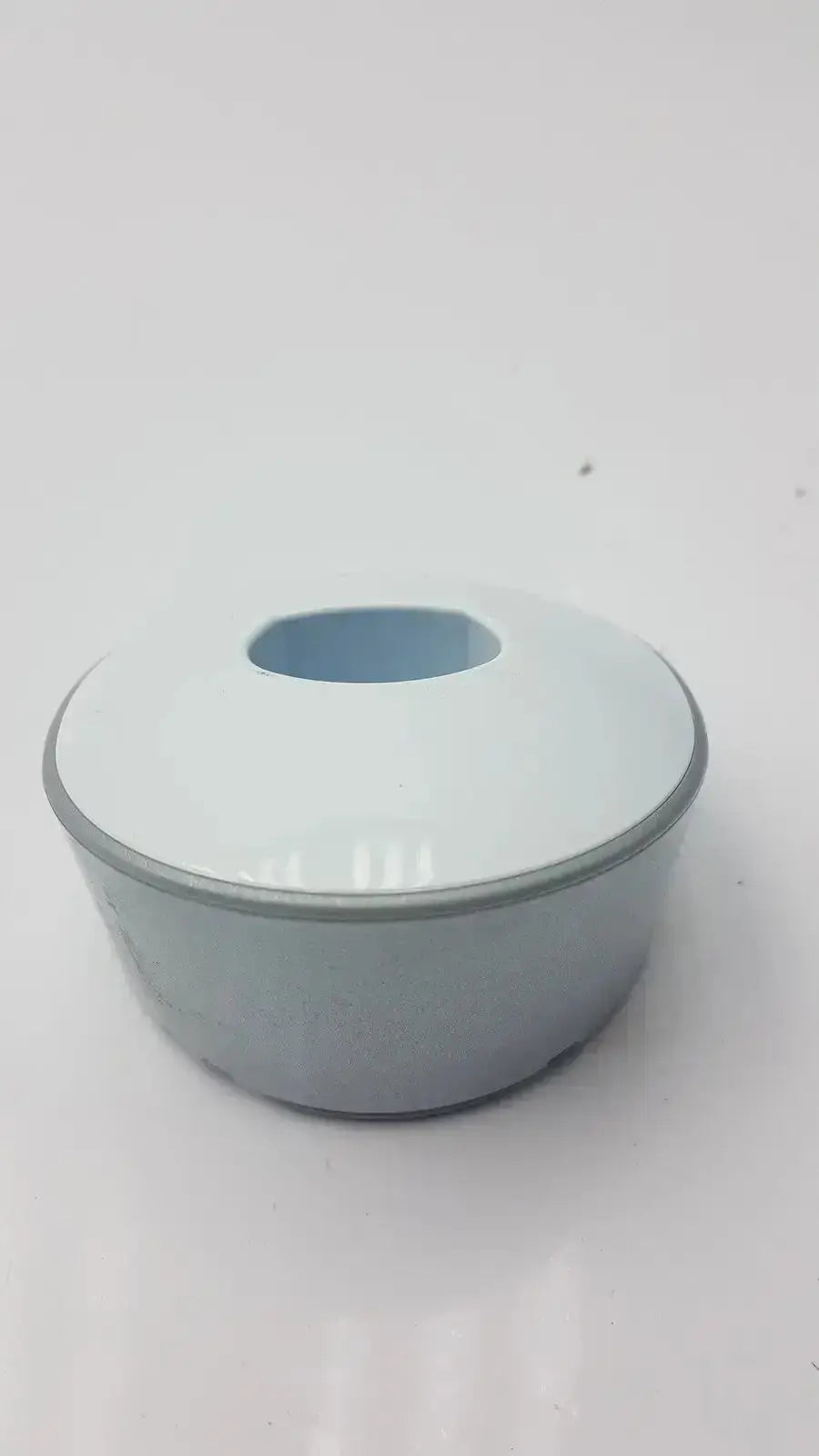 Light blue ceramic bowl with matching lid and gray rim shown alongside dentsply sirona smartlite focus curing light charger base only