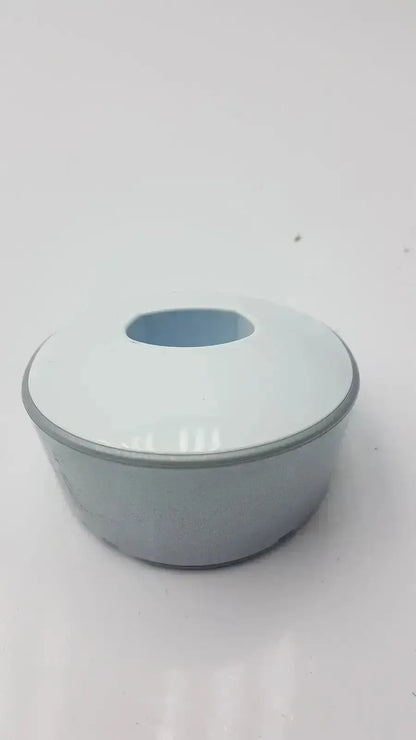 Light blue ceramic bowl with matching lid and gray rim shown alongside dentsply sirona smartlite focus curing light charger base only