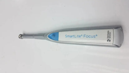 Silver and blue handheld dental curing light with smartlite focus branding for precise dental curing polymerization