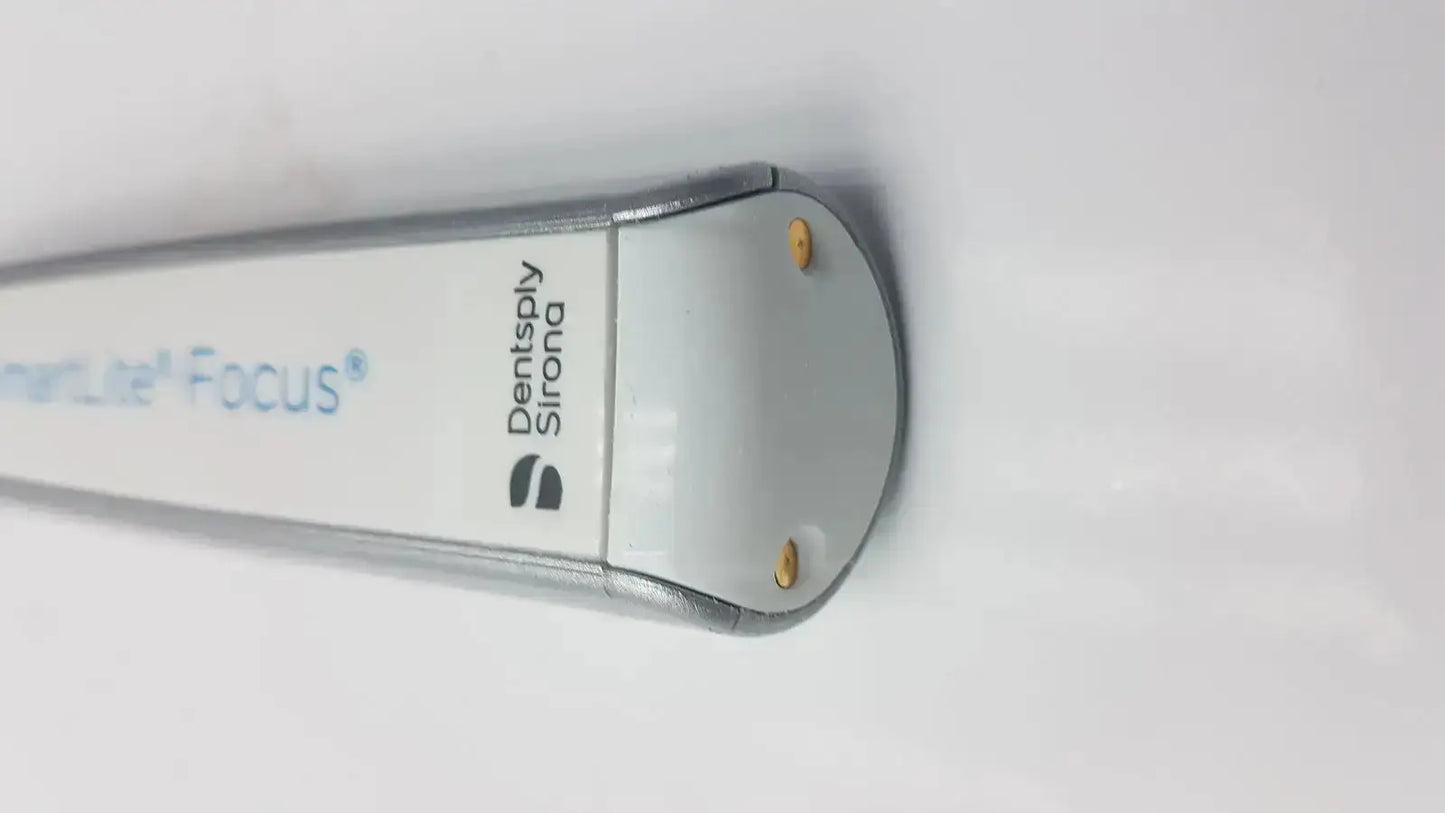Silver and white dentsply sirona smartlite focus dental curing light with sleek cylindrical design for dental curing use