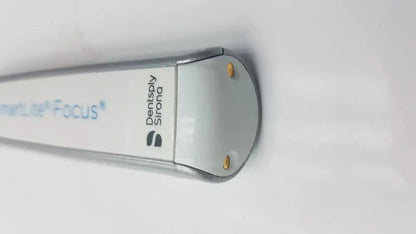 Silver and white dentsply sirona smartlite focus dental curing light with sleek cylindrical design for dental curing use