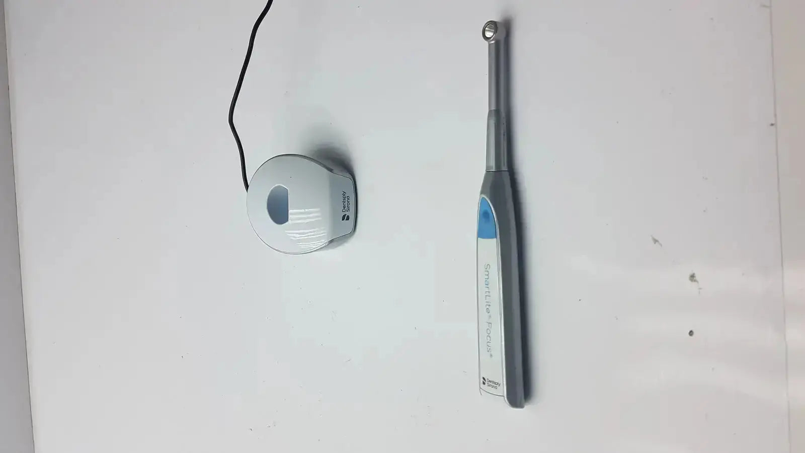 Gray and blue handheld dentsply sirona smartlite focus dental curing light with ergonomic design for dental curing use