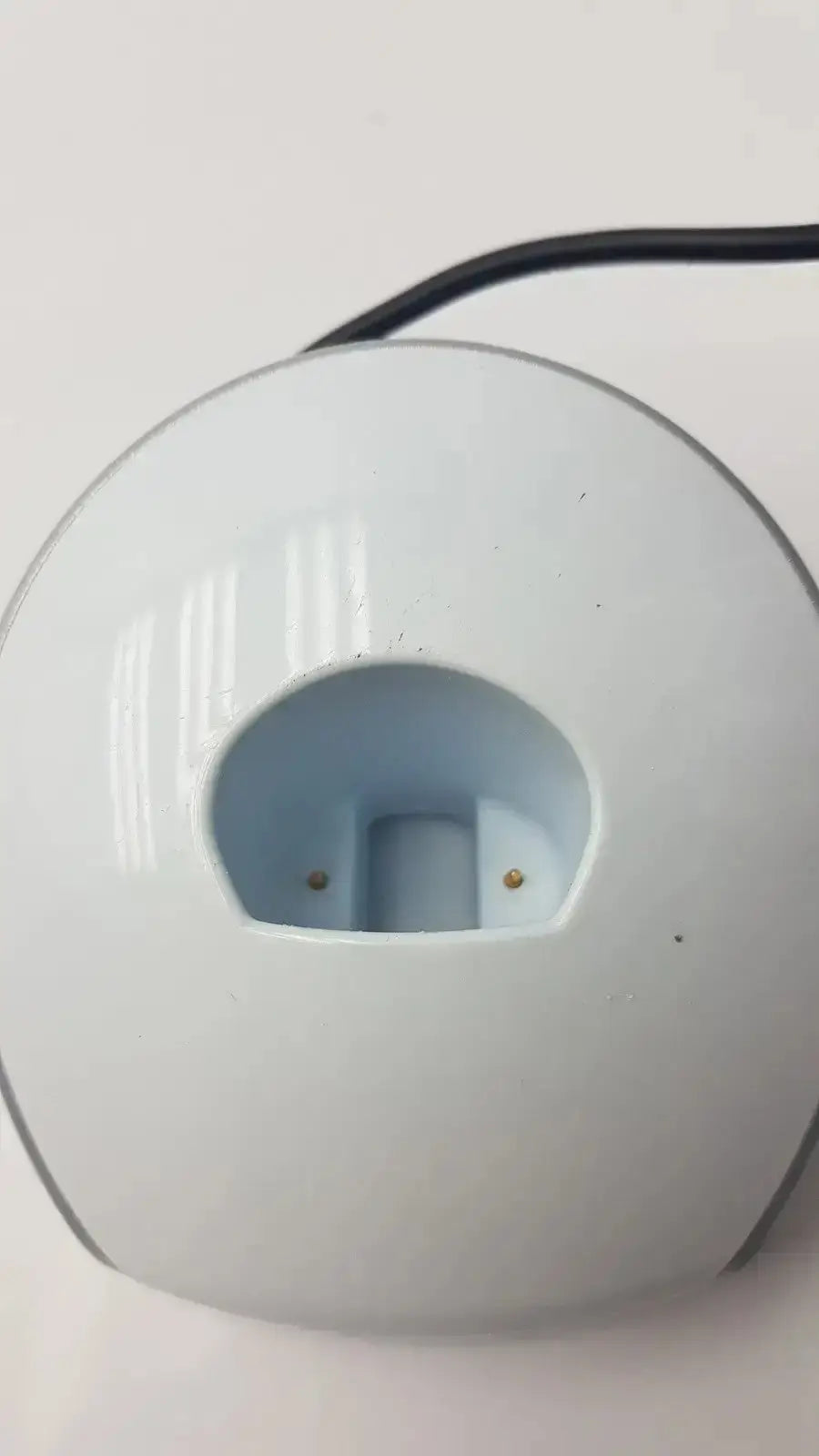 White circular dental curing light charger with a glossy finish and gold contact points for dentsply sirona smartlite focus