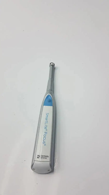 Silver and blue dentsply sirona smartlite focus dental curing light handpiece for efficient dental curing procedures