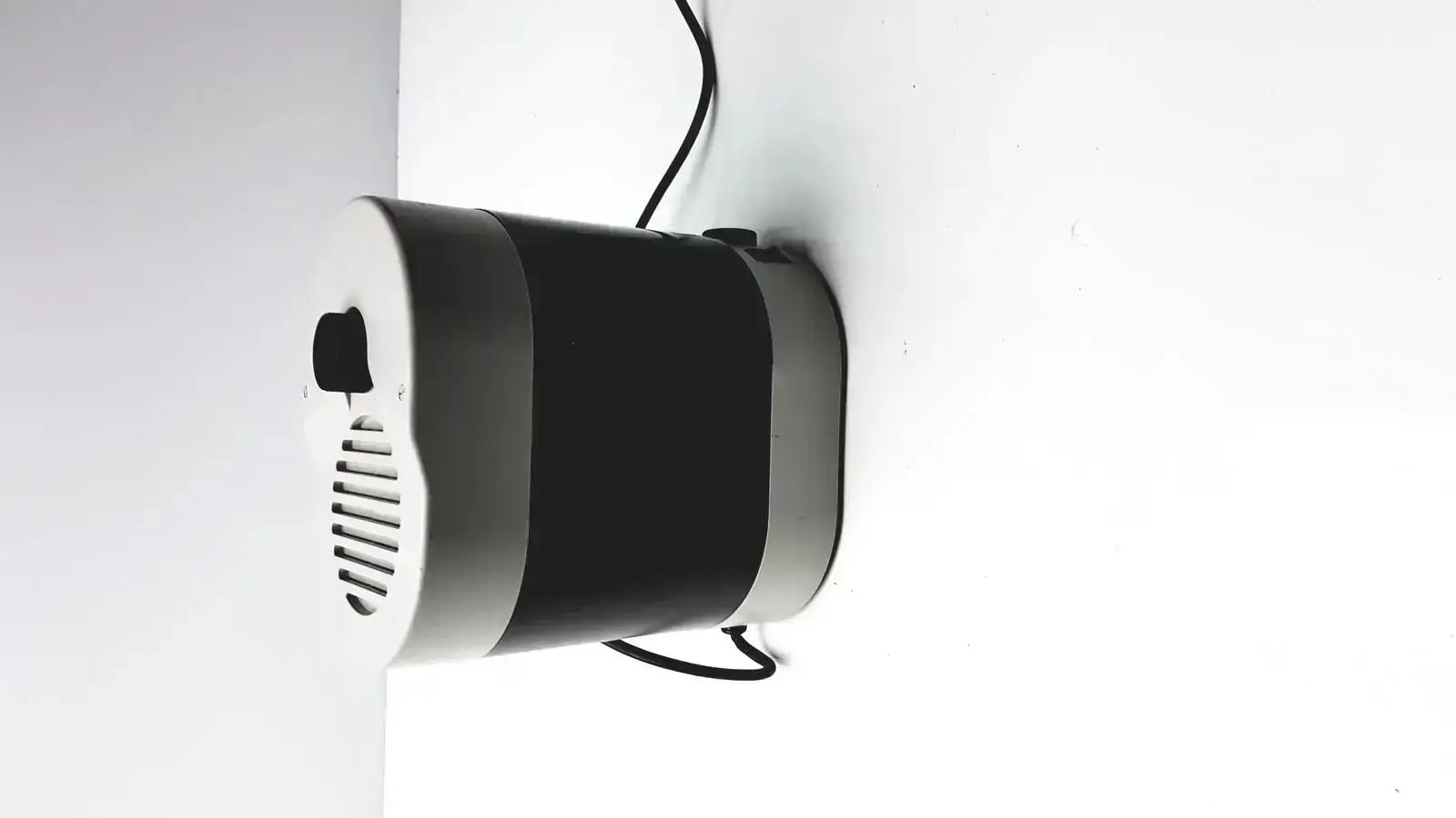 Black and silver cylindrical wall-mounted air purifier with vented front panel for dentsply triad 2000 visible light cure system