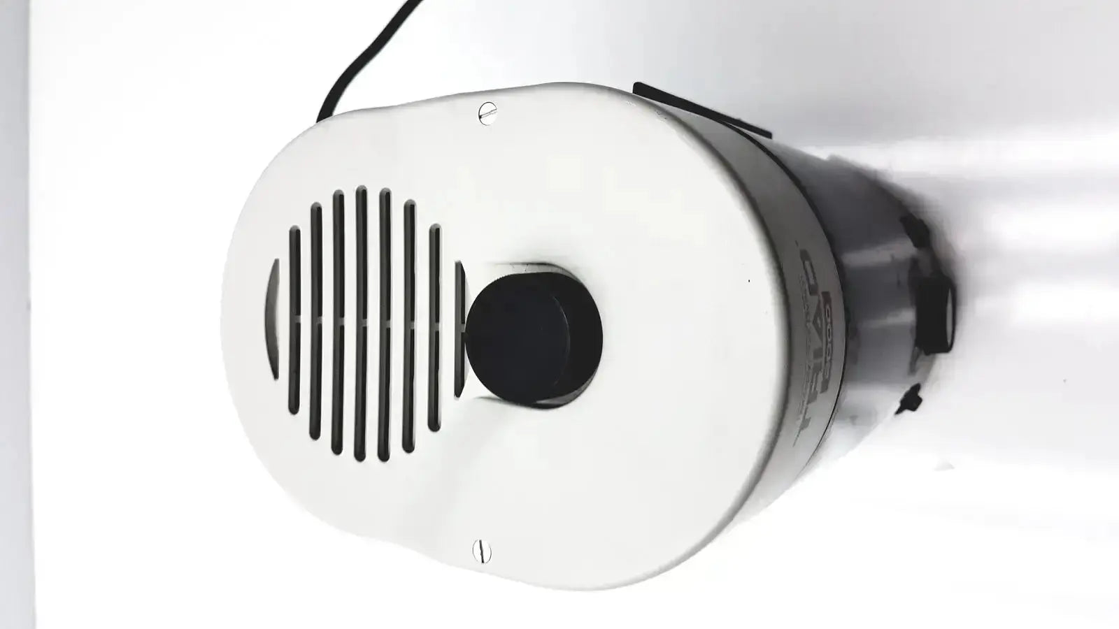 White cylindrical dentsply triad 2000 visible light cure speaker with black slits and matte finish front panel for trubyte curing