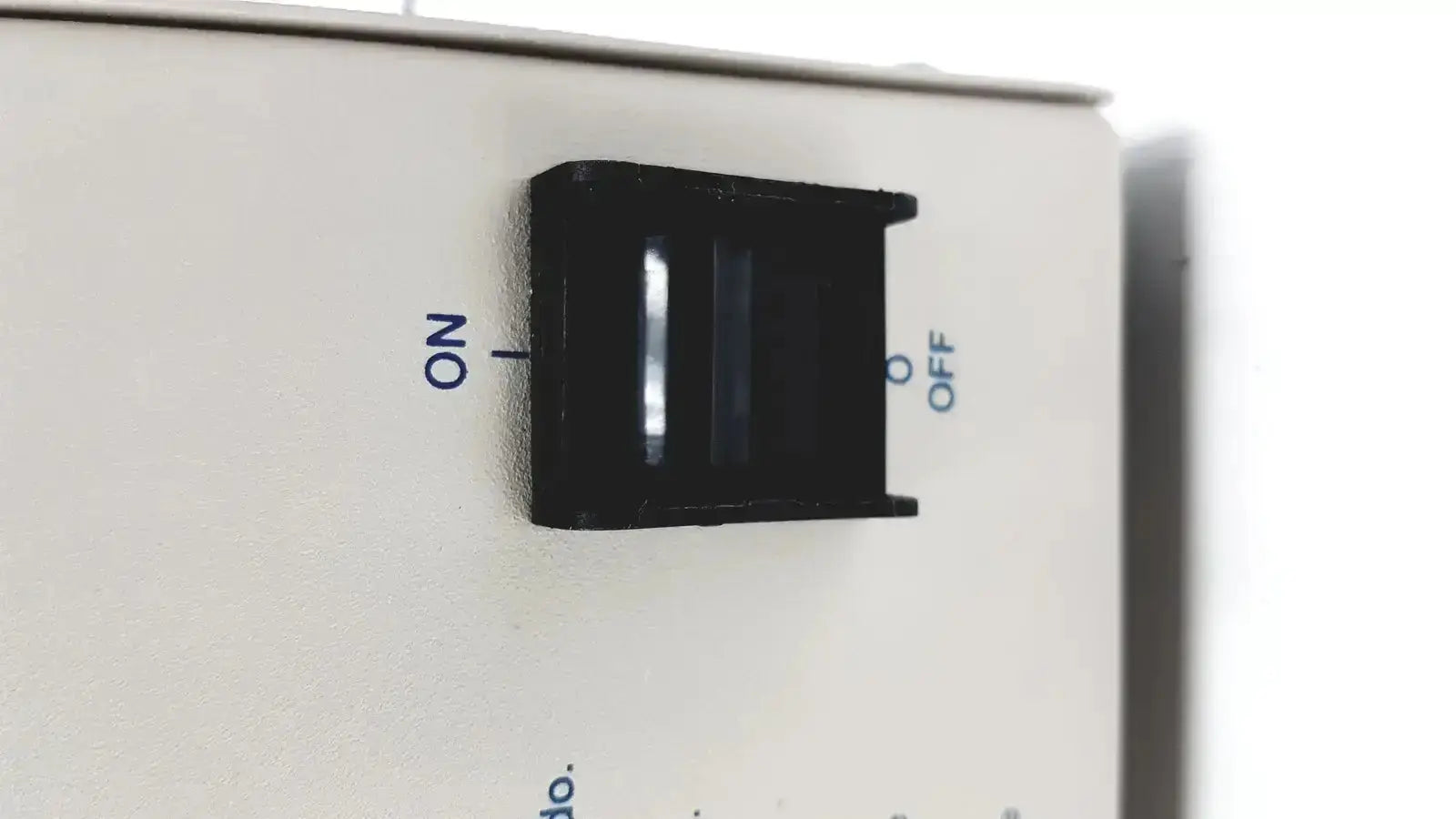 Black plastic toggle switch with on and off labels on white panel of devilbiiss heavy duty aerosol compressor 8650d used medical equipment for sale