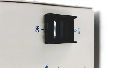 Black plastic toggle switch with on and off labels on white panel of devilbiiss heavy duty aerosol compressor 8650d used medical equipment for sale