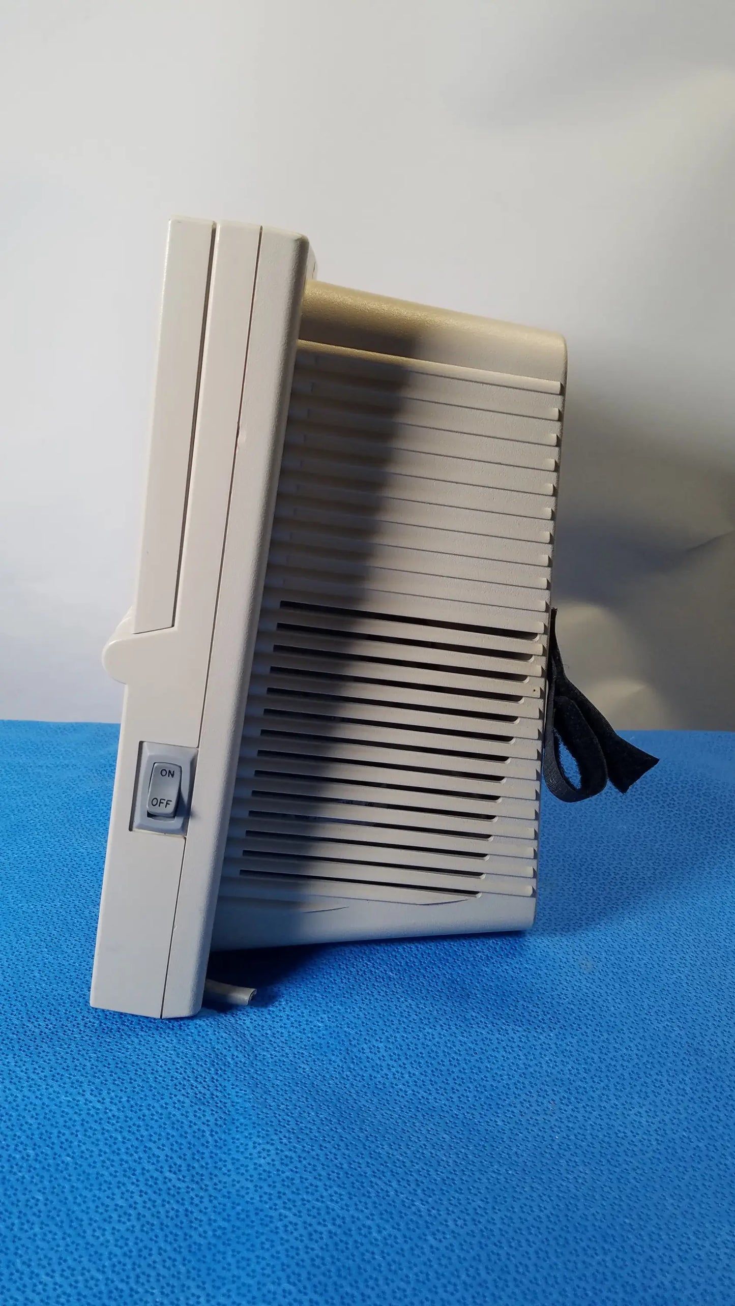 Beige plastic atari 2600 video game console with vertical slot and vented side panel shown with medical equipment reuse context