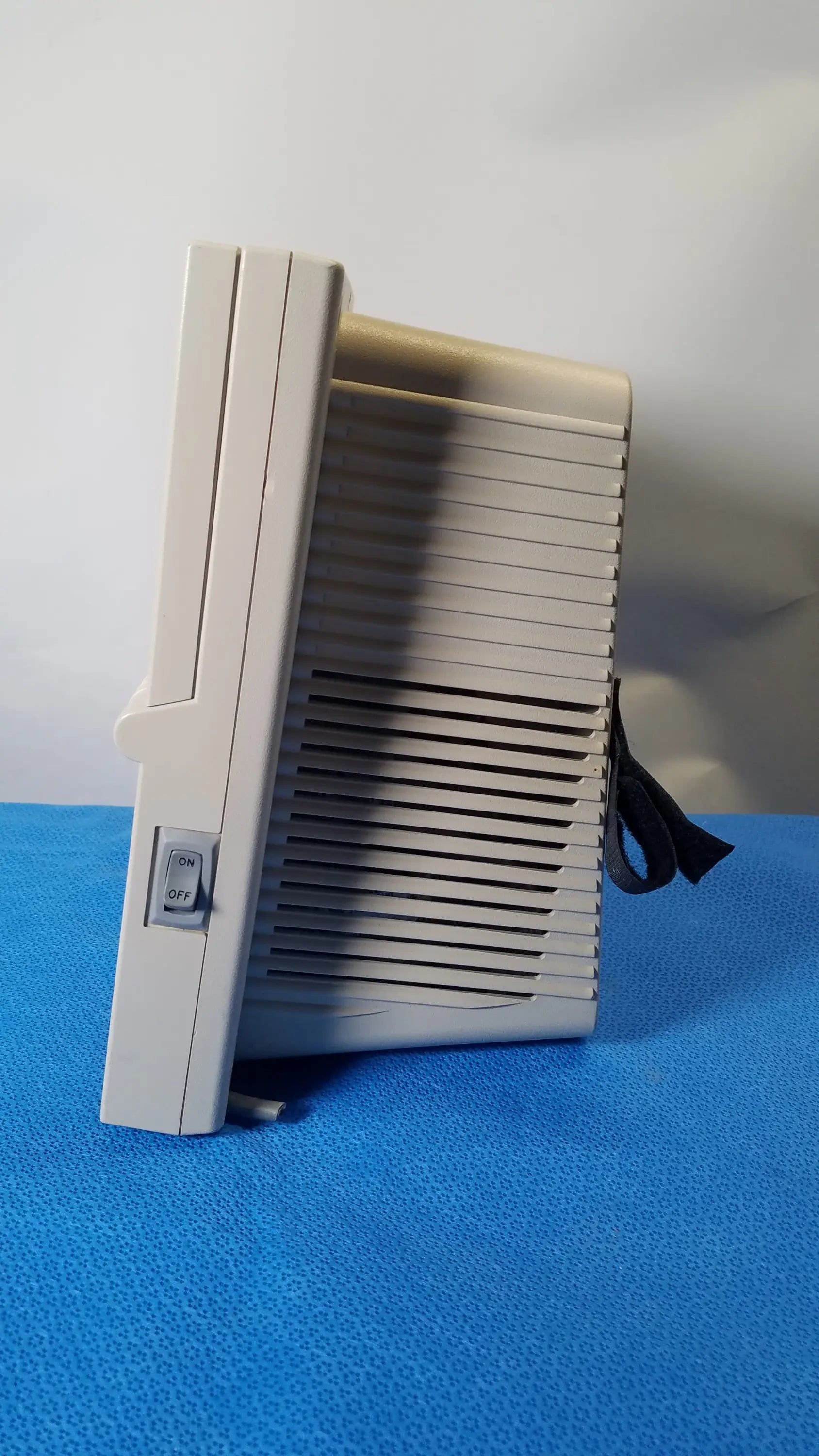 Beige plastic atari 2600 video game console with vertical slot and vented side panel shown with medical equipment reuse context