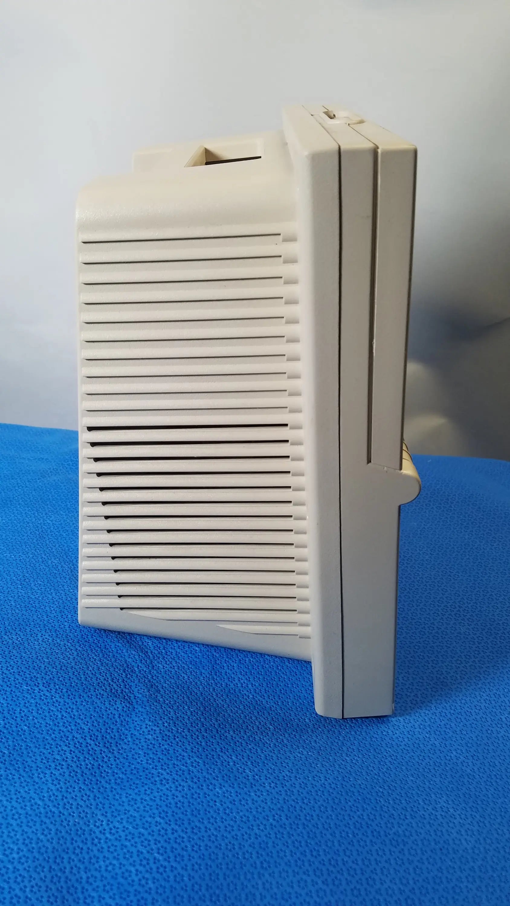 Beige plastic DeVilbiss 5650D Pulmo-Aide compressor nebulizer with vertical slatted front panel for medical equipment reuse