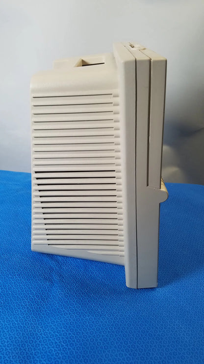 Beige plastic DeVilbiss 5650D Pulmo-Aide compressor nebulizer with vertical slatted front panel for medical equipment reuse