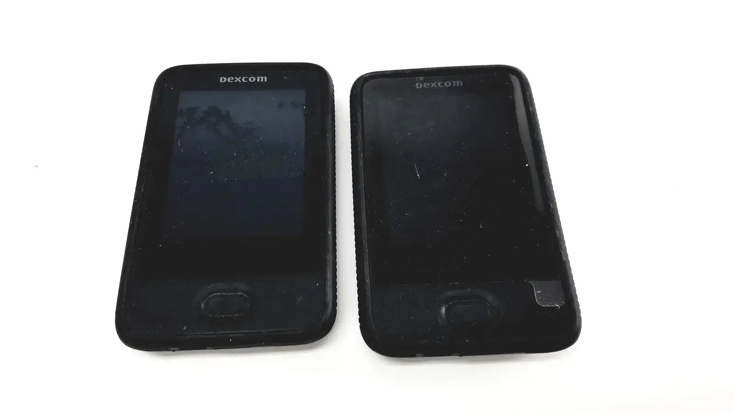Black dexcom g6 receiver with rectangular screen and physical button for reuse medical glucose monitoring