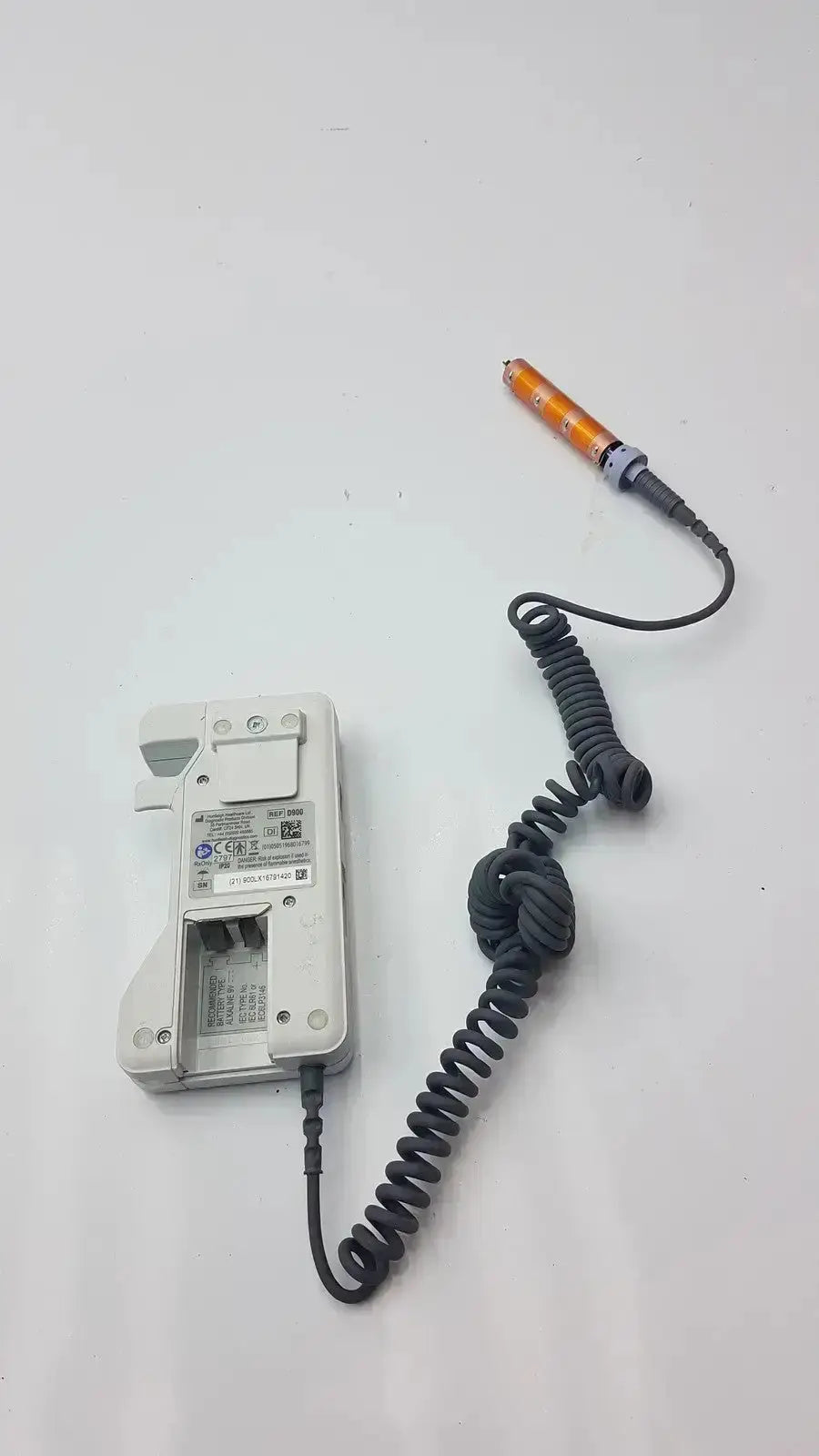 White plastic battery charger with coiled black cable and orange probe for doppllex d900 handheld portable doppller