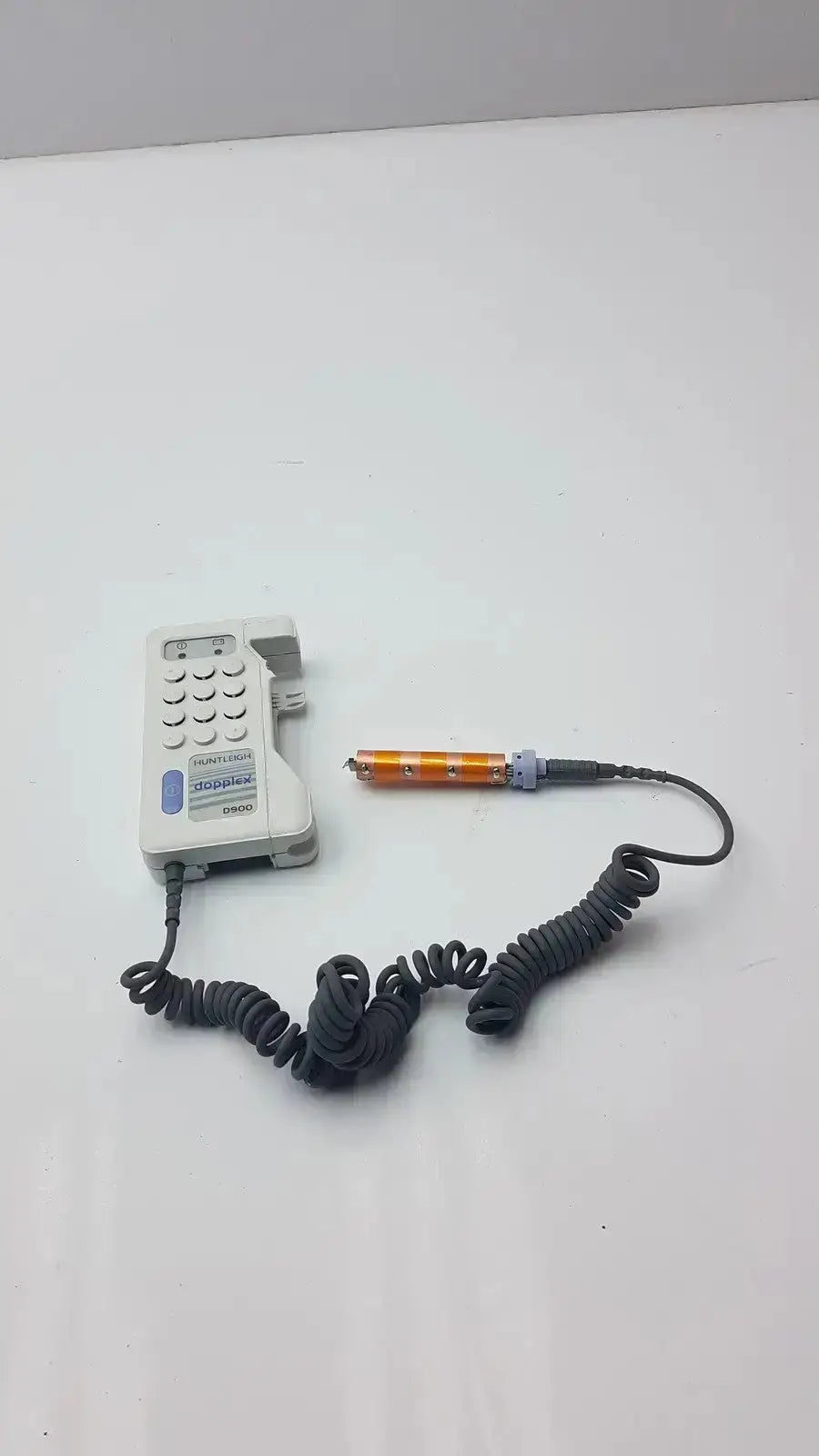 Gray plastic doppllex d900 handheld portable doppller with coiled black cable and orange-tipped sensor attached