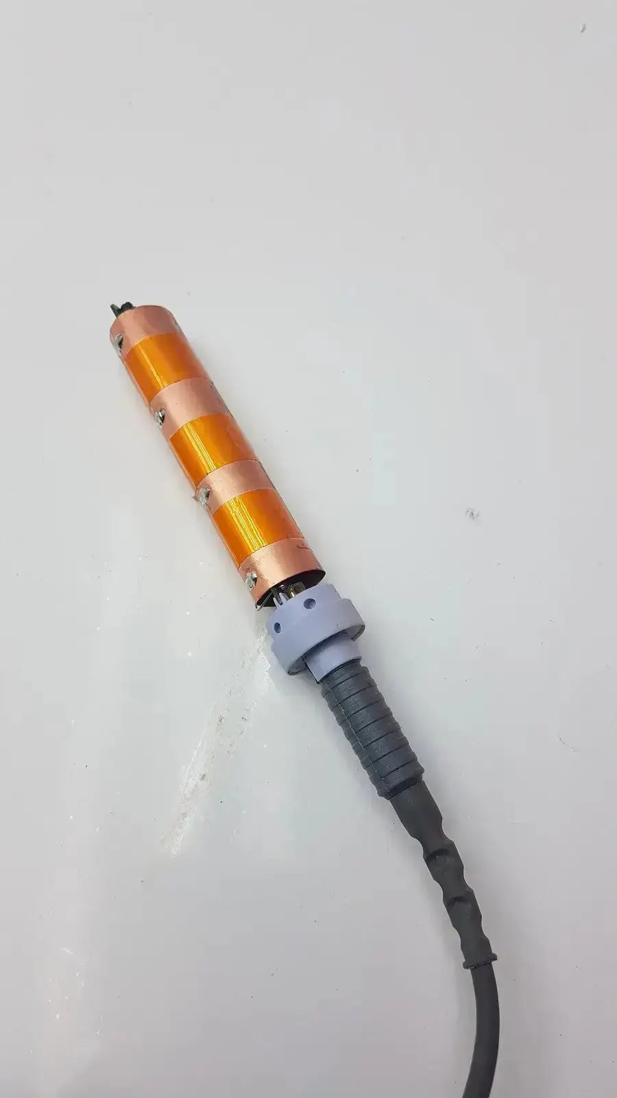 Doppllex d900 handheld portable doppller featuring an orange and copper striped curling iron with a gray handle