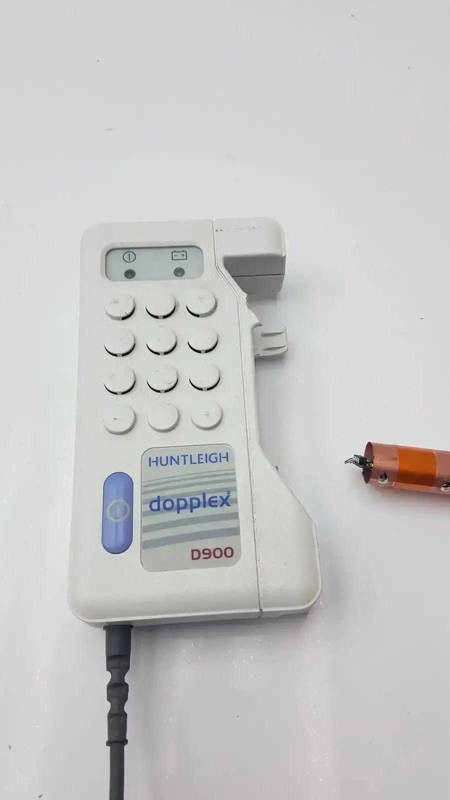 White plastic huntleigh doppllex d900 handheld portable doppller with keypad and attached cable for medical use