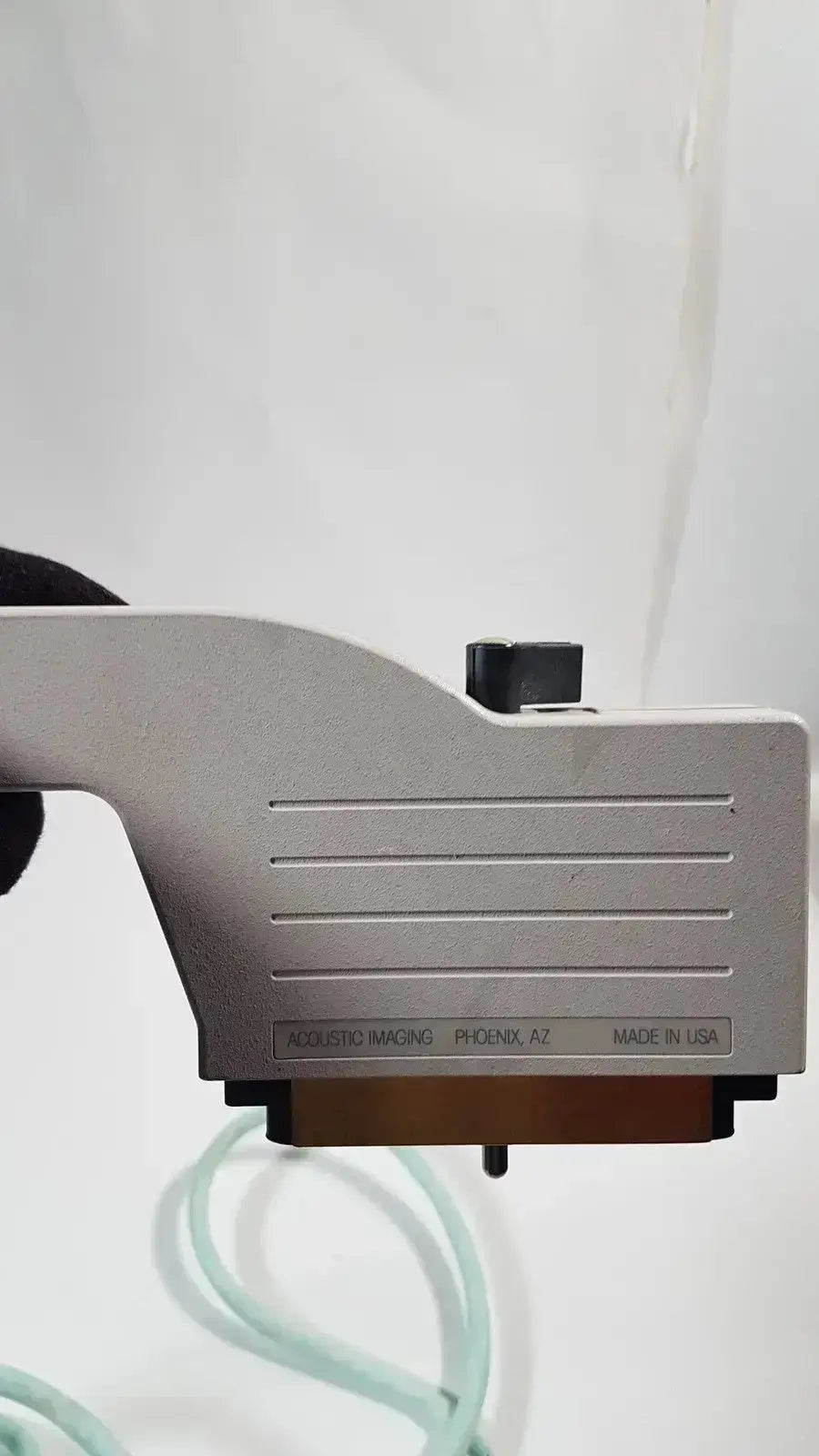 Silver-colored dornier acoustic imaging curved array ultrasound transducer with matte finish and horizontal ridges