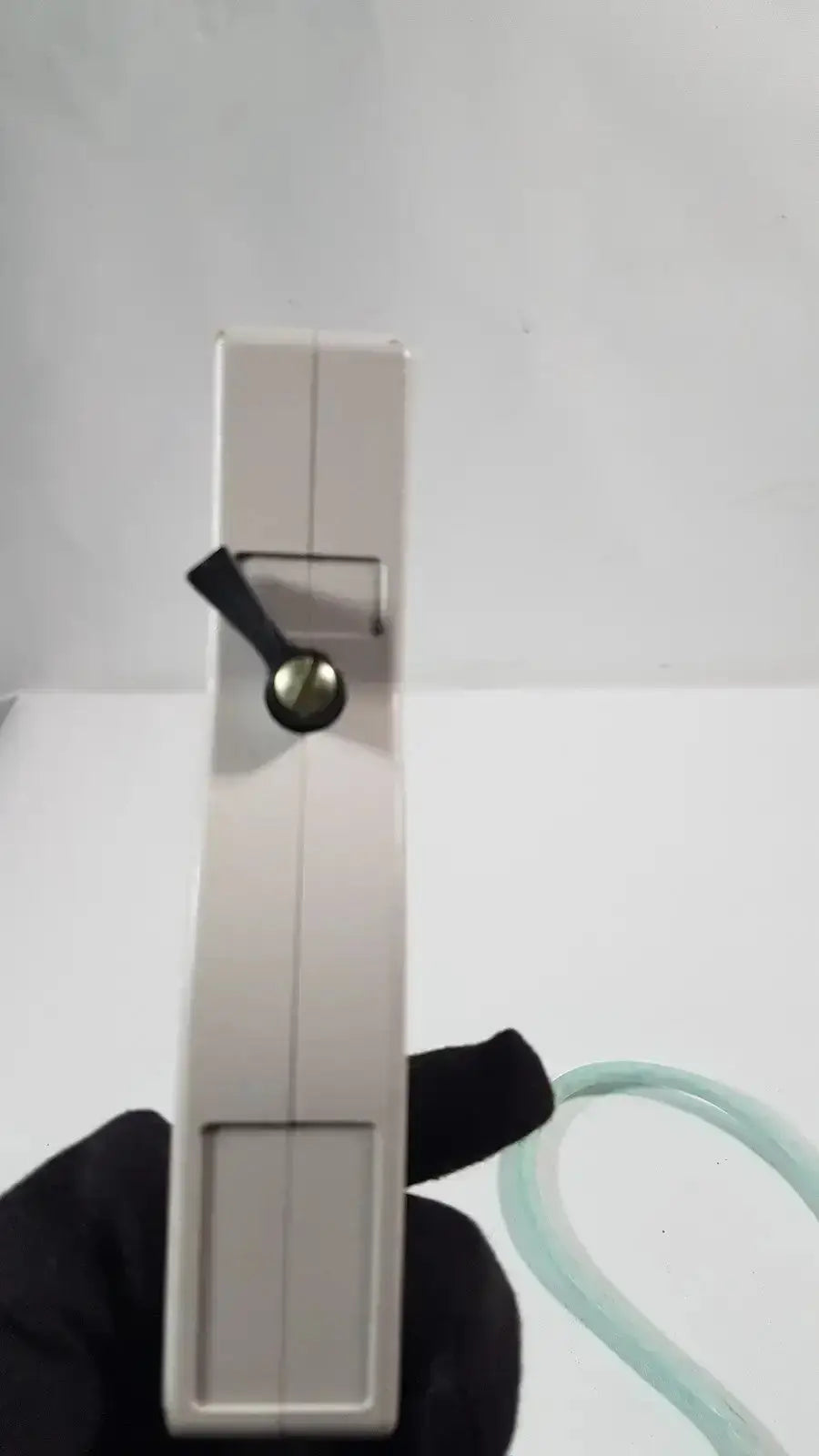 Beige plastic hand-held dornier acoustic imaging curved array ultrasound transducer with black toggle and green tube