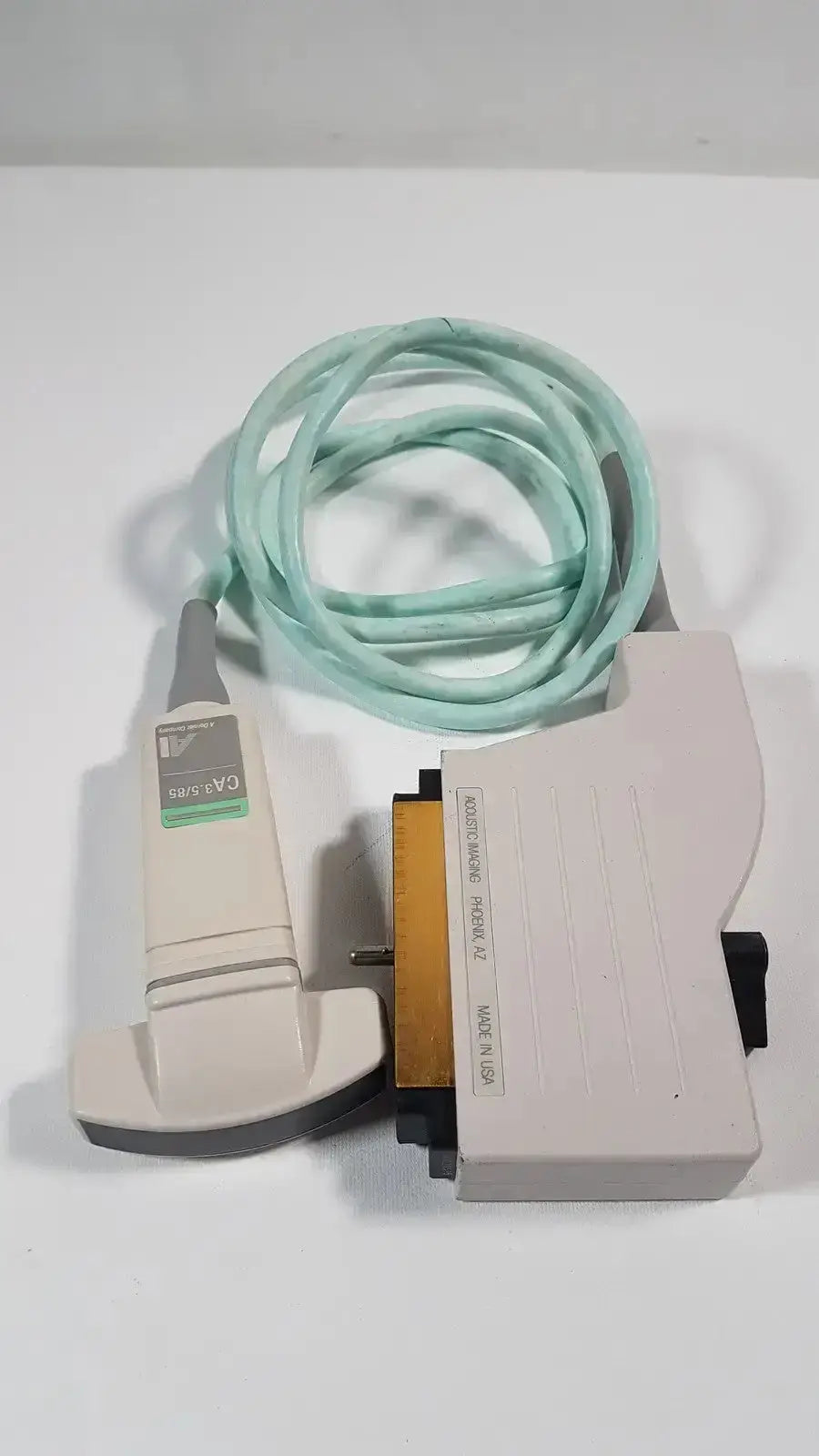 Beige dornier acoustic imaging ai ca 3.5 85 curved array ultrasound transducer with light green coiled cable