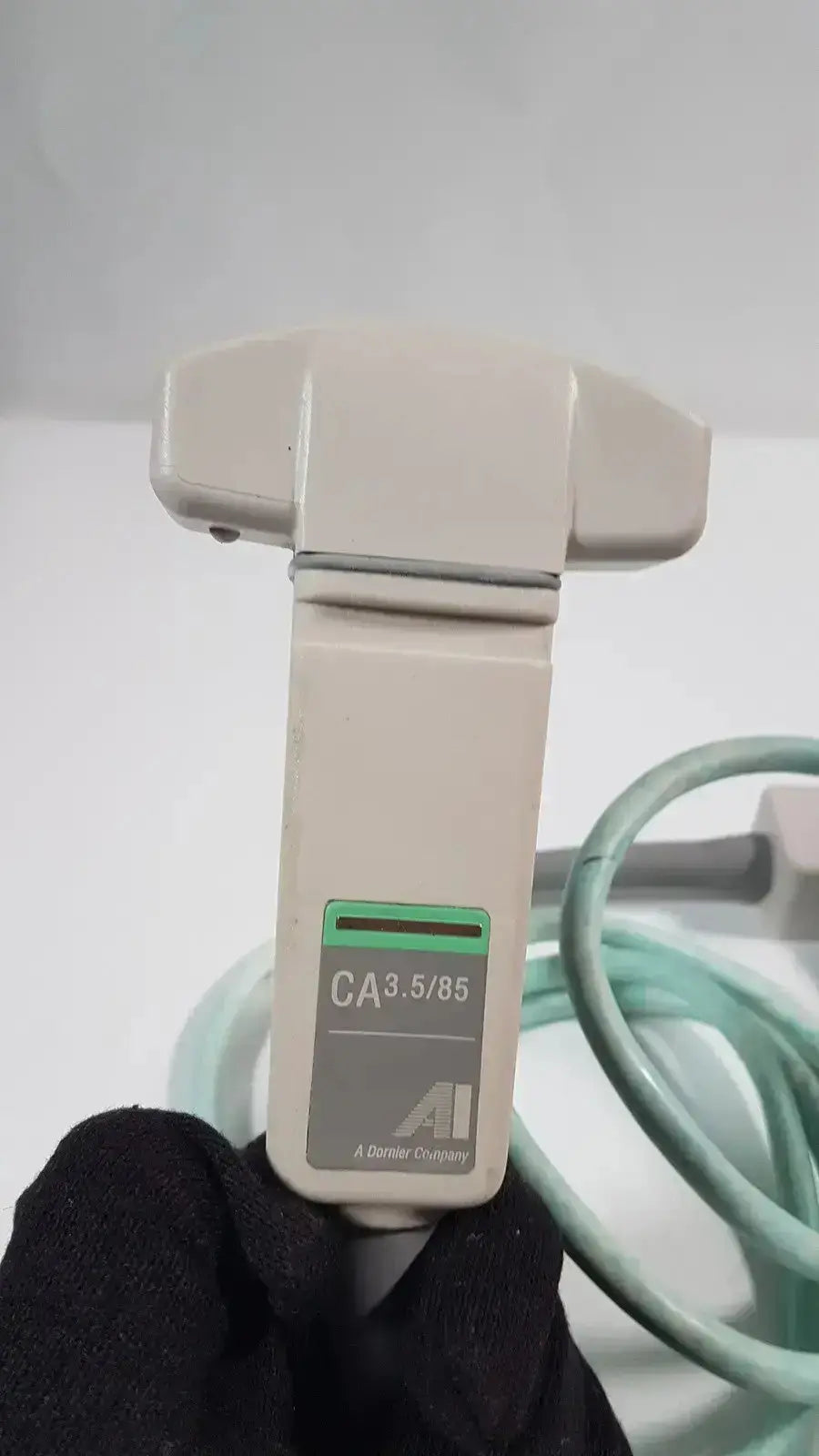 Beige plastic dornier acoustic imaging curved array ultrasound transducer with green and gray label ca3.5/85