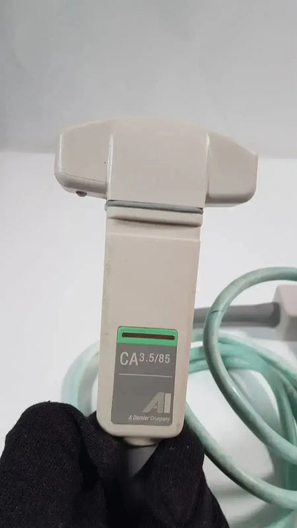 Beige plastic dornier acoustic imaging curved array ultrasound transducer with green and gray label ca3.5/85