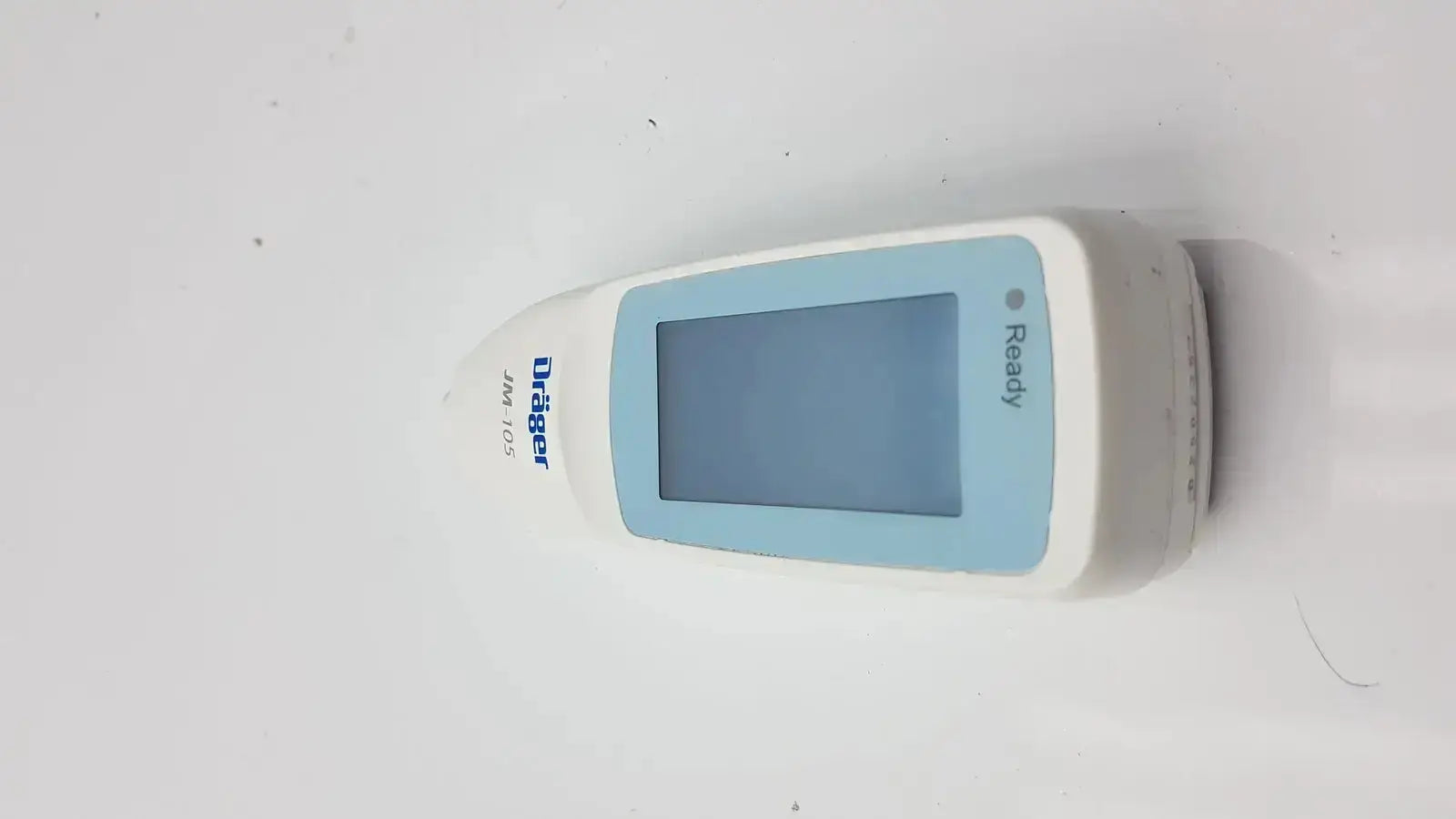 White and light blue drager jaundice meter jm-105 handheld device with rectangular screen displaying ready message