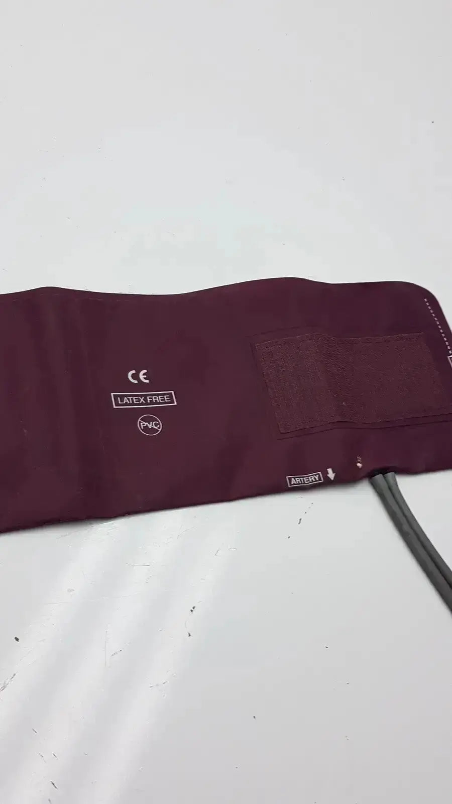 Maroon latex-free pvc Dura Cuff Critikon blood pressure cuff 2204 with velcro patch and attached tubing for blood pressure