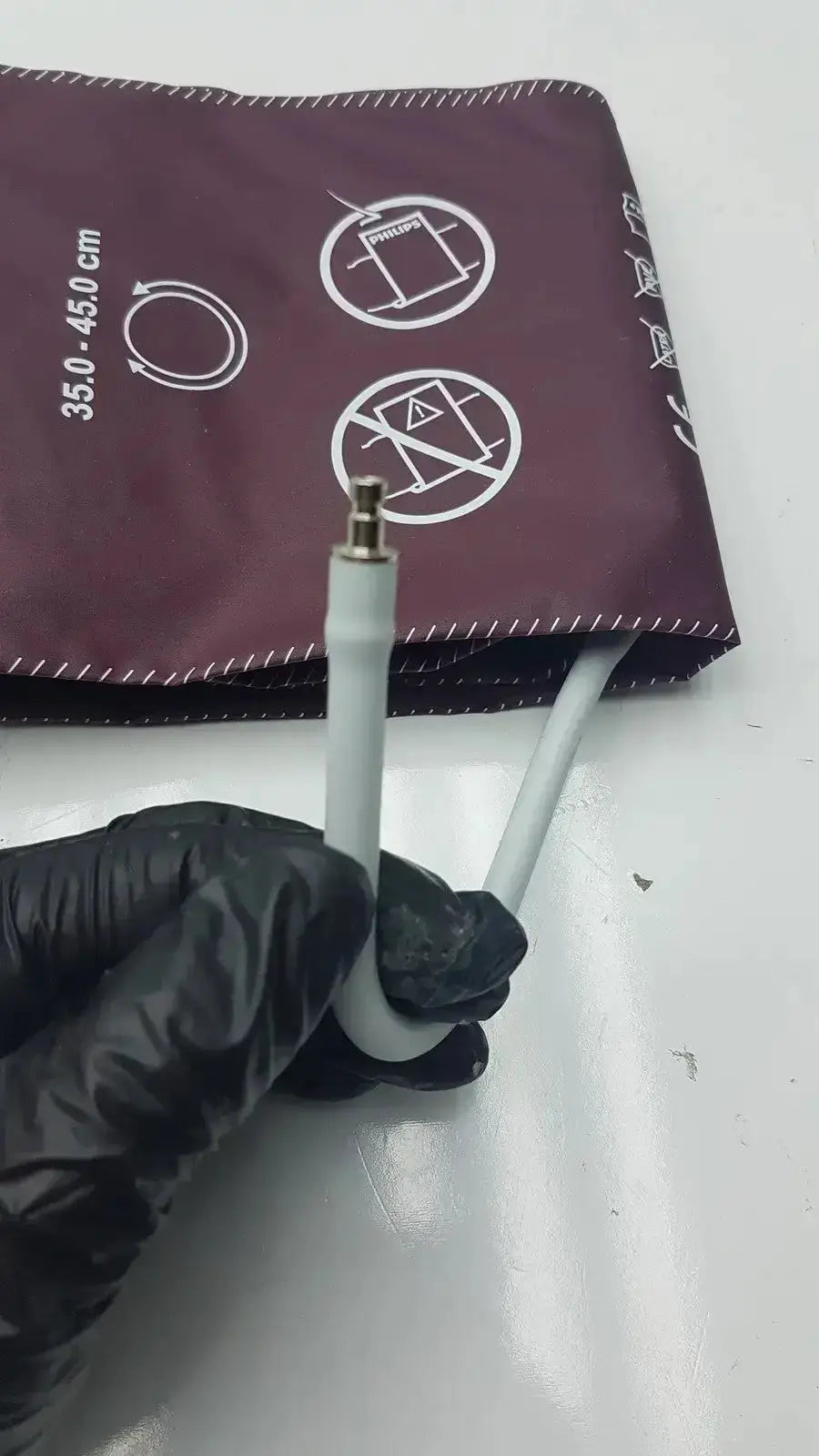 Dura Cuff Critikon blood pressure cuff model 2204 maroon with white tubing and metallic connector for accurate pressure measurement