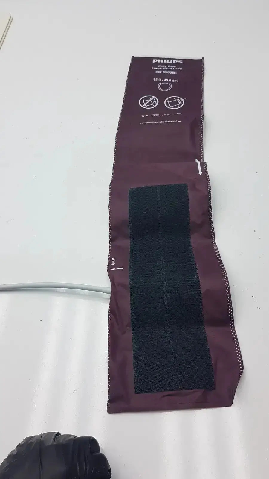 Dura cuff Critikon blood pressure cuff model 2204 in maroon with black velcro strap for accurate blood pressure measurement