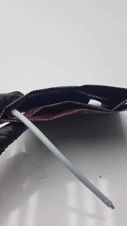 Dura Cuff Critikon blood pressure cuff model 2204 featuring a dark maroon fabric pressure cuff with white stitching and metal rod