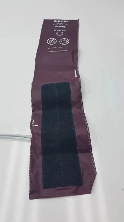 Dura cuff critikon blood pressure cuff model 2204 in maroon with black velcro strips for accurate blood pressure monitoring