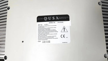 White rectangular label with black text and warning symbol on the back of dusa blu blue light photodynamic therapy system