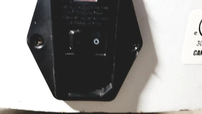 Black hexagonal plastic device with screws and hole on the back of dusa blu blue light photodynamic therapy system 4170-2