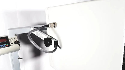 White industrial dusa blu blue light photodynamic therapy system with black coiled cable and metallic connector