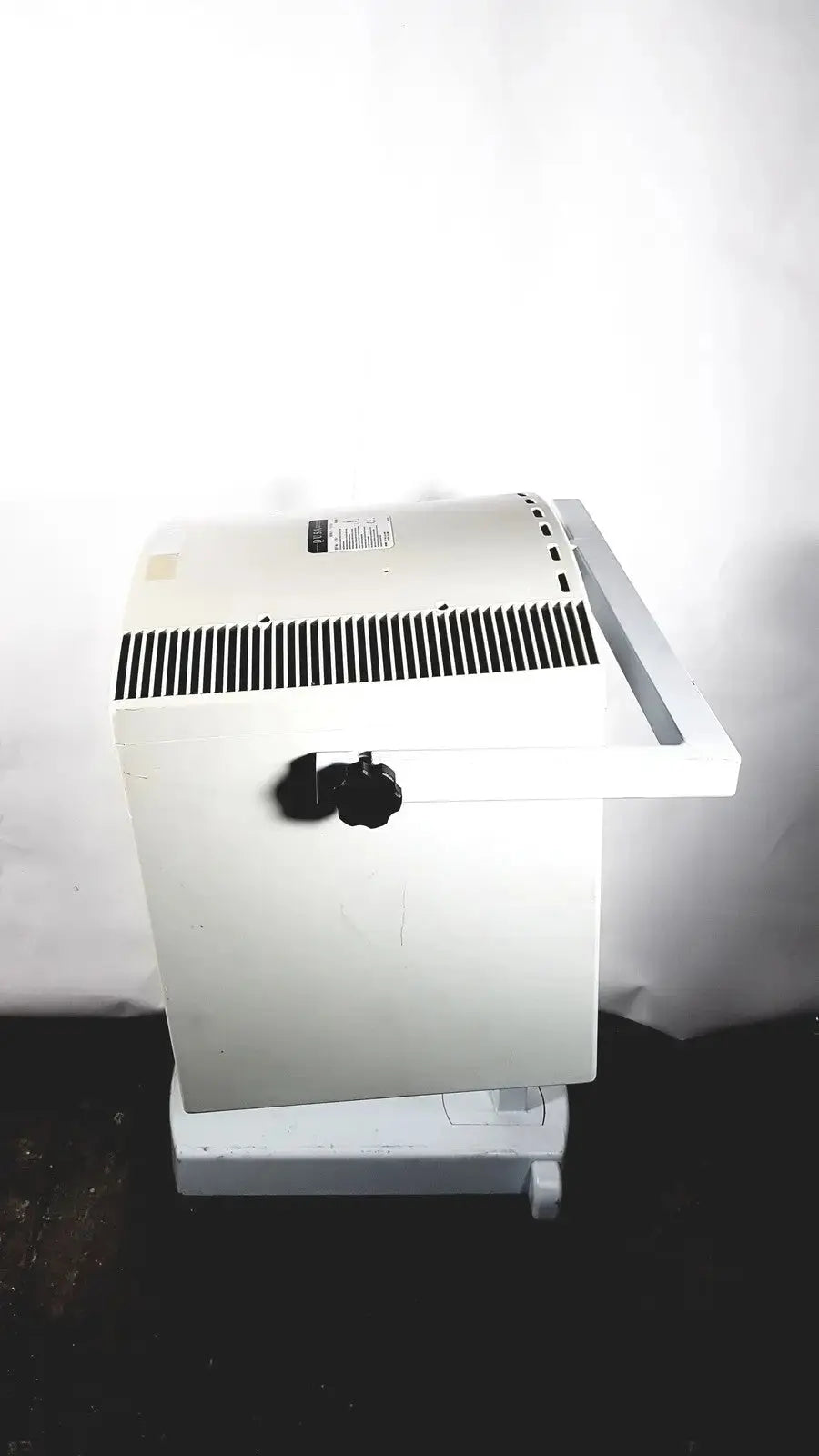 White industrial-grade electric heater with black vent grille and knob for dusa blu blue light photodynamic therapy system