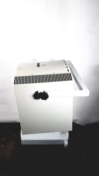 White industrial-grade electric heater with black vent grille and knob for dusa blu blue light photodynamic therapy system