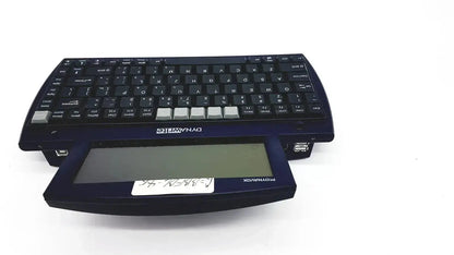 Black plastic Dynavox Dynawrite speech processor laptop with silver keycaps and integrated touchpad keyboard