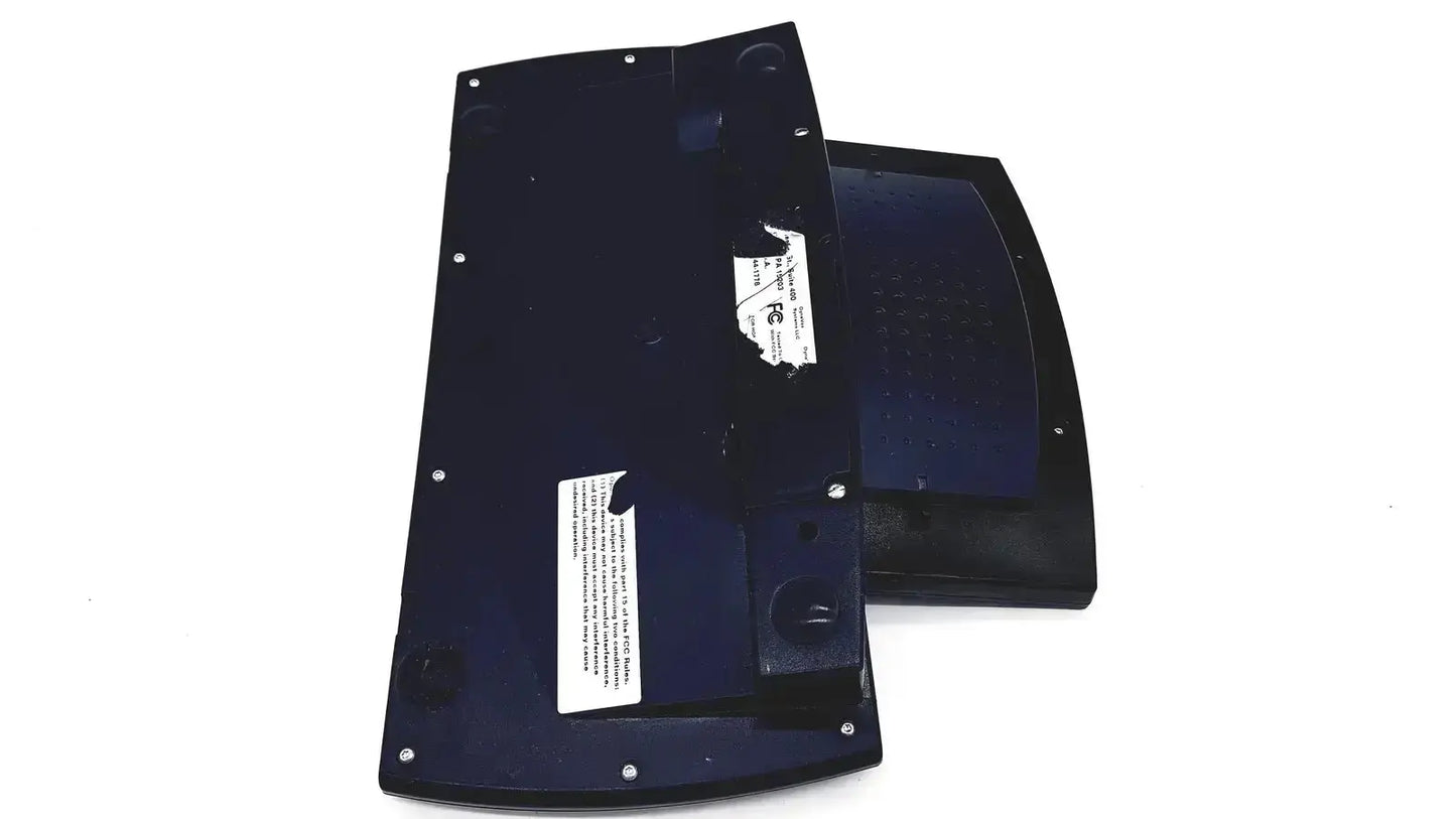Black plastic keyboard base with silver screws and white labels on the back side of dynavox dynawrite speech processor laptop