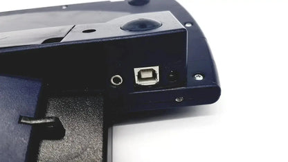 Black plastic dynavox dynawrite speech processor laptop computer back side showing silver usb port and circular audio jack