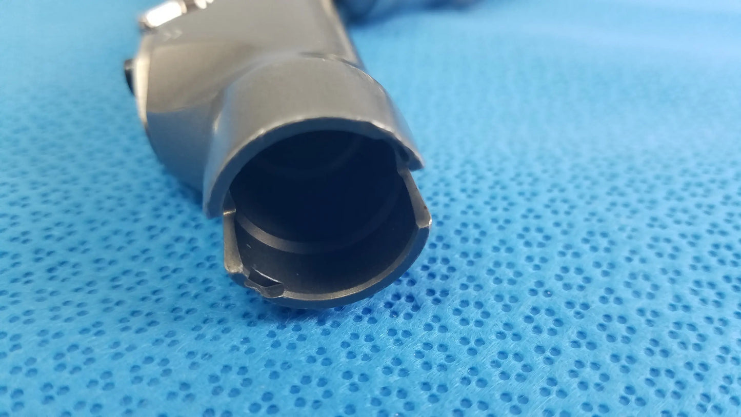 Gray metallic cylindrical powermax elite shaver handpiece connector with hollow interior and visible mechanical fittings for medical equipment