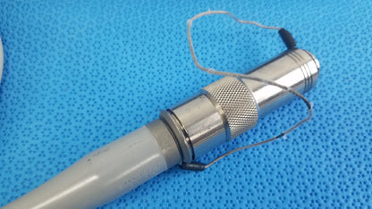 Dyonics powermax elite shaver handpiece featuring a silver metallic textured grip and gray plastic handle medical equipment