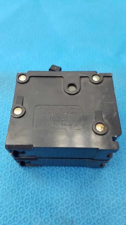 Black plastic Eaton BR220 2-pole 20 amp circuit breaker with gold terminal screws rated for 10,000-volt AC reuse medical equipment