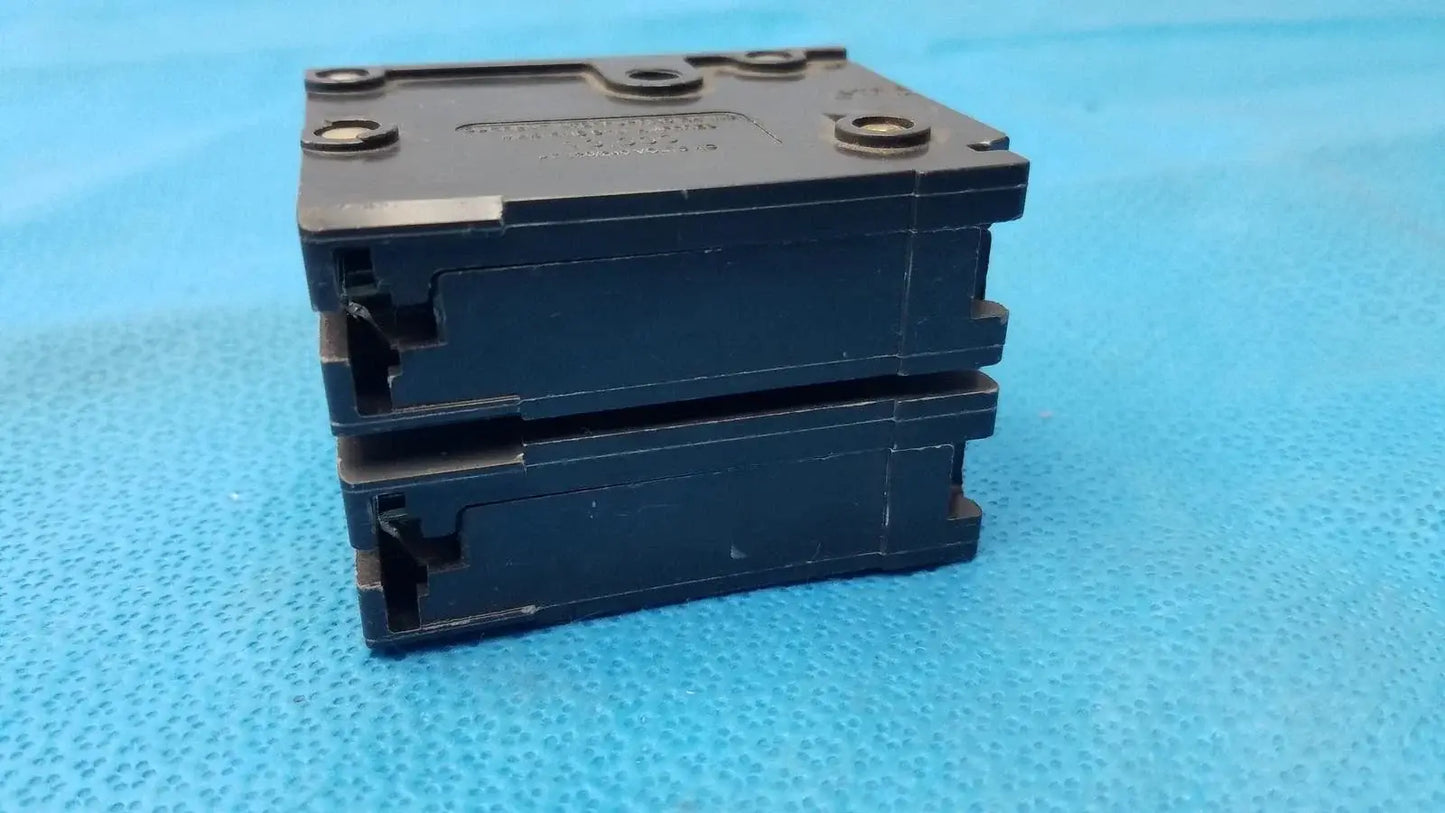 Stack of three black plastic eaton br220 2-pole 20 amp circuit breaker units for reuse medical equipment safety